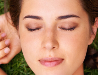 brown haired woman with eyes closed