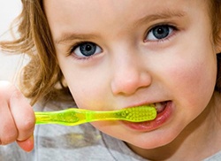 young girl holding toothbrush