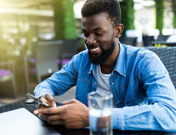 person sitting at a restaurant and looking at their phone