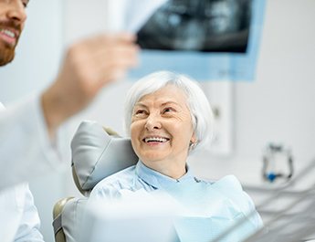 Older patient smiling at dentist. 