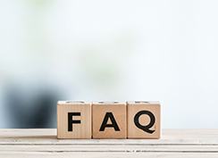 Wooden letter blocks spelling out FAQ on ledge