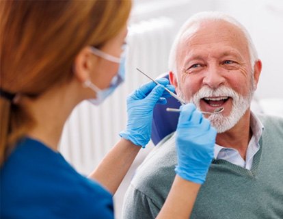 a patient smiling while visiting his dentist