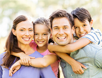 beautiful family of four smiling big