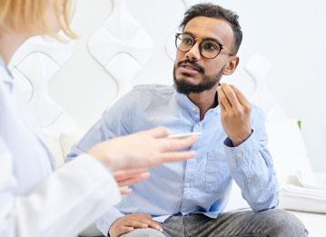 person speaking to their dentist