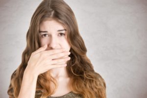 A woman covering her mouth.