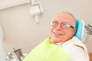 older man smiling wearing glasses