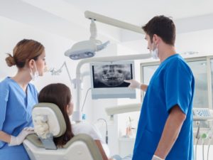 dentist showing a patient an x-ray