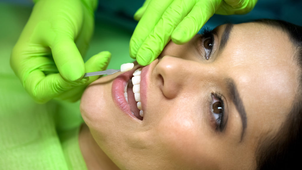 young woman smiling while having porcelain veneers in manchester placed