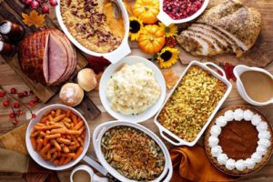 Dinner table covered with holiday foods