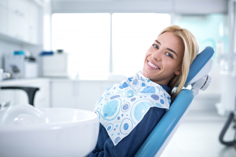 person with dental sealants smiling at dentist