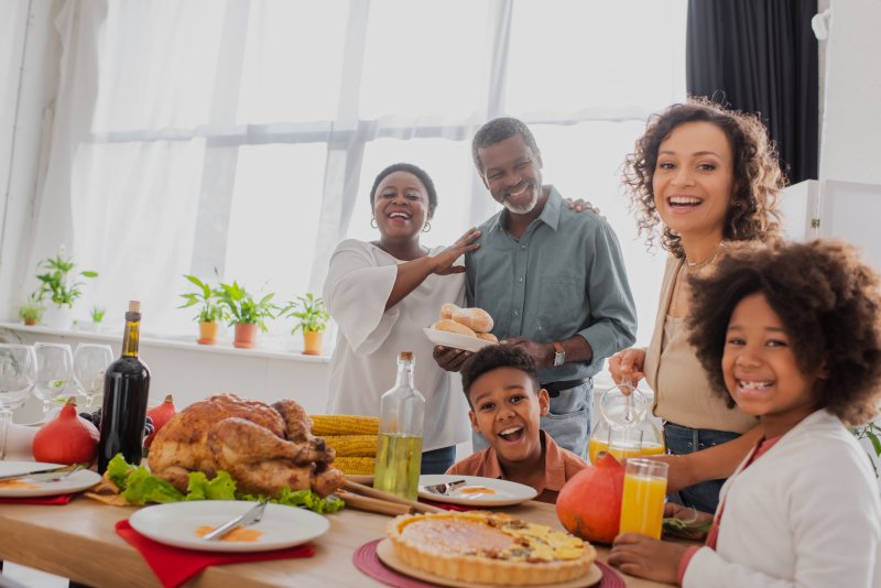 A modern family enjoying Thanksgiving with good dental health